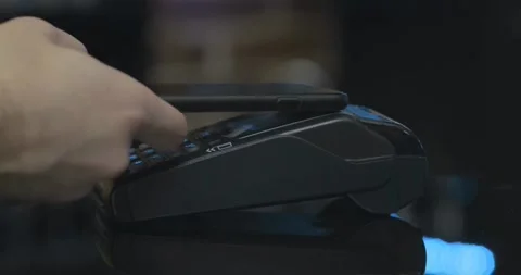Person using contact less payment with smartphone payment terminal Point of Sale Stock Footage 336585633
