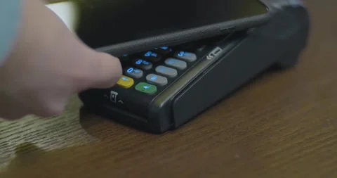 Person using contact less payment with smartphone payment terminal Point of Sale Stock Footage 336585636