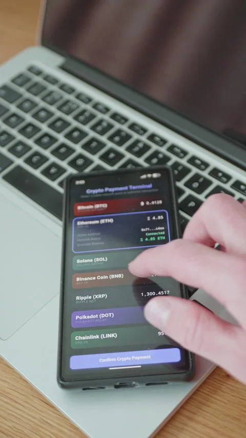 Person using a cryptocurrency payment terminal app on a smartphone Stock Footage 335528925