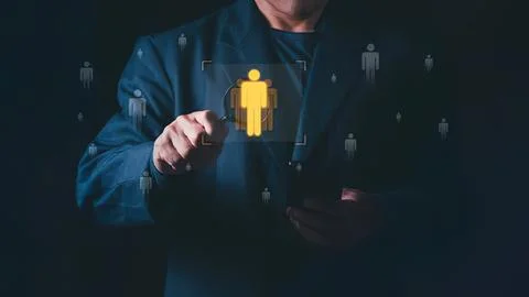 Person using digital interface with human icons on screen Stock Photos