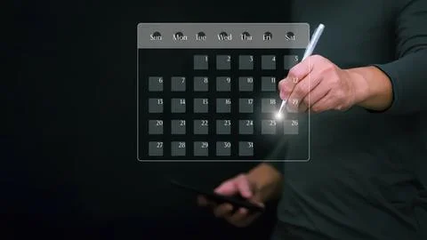 Person using digital pen to write on a virtual calendar Stock Photos
