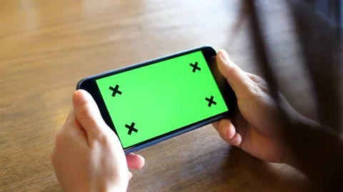 Person Using Digital Smart Phone in Landscape Mode Green Screen Background, Vídeos de archivo 336585745
