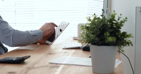 Person using digital tablet computer in bright modern office workplace Stock Footage 123947026