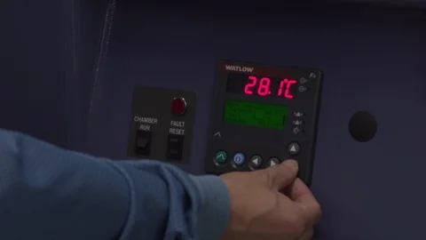 Person using a digital thermostat machine Stock Footage 106900032