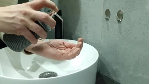 Person using dispenser to apply liquid soap Stock Footage 296771717