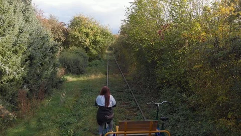 A person using a draisine alone some abandoned train tracks in Germany 스톡 동영상 118387834