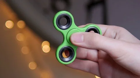 Person using a Fidget spinner Stock Footage 75839321