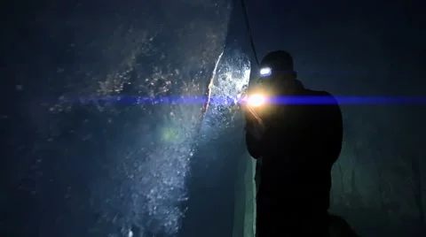 Person using flashlight to discover ice glacier cave. adventure background Stock-Footage 42947684