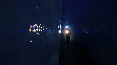 Person using flashlight to discover ice glacier cave. mystical scene Stock Footage 64799587