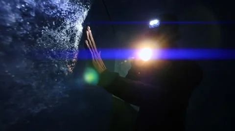 Person using flashlight to discover ice glacier cave. adventure background Vidéo 64802385