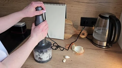 Person Using Garlic Press in Modern Kitchen Setting Stock Footage 305750293