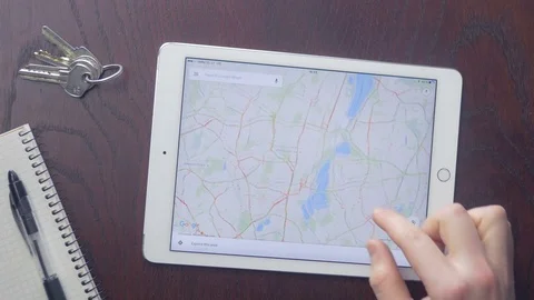 Person using Google Maps app on Apple iPad screen at home Stock Footage 75460694