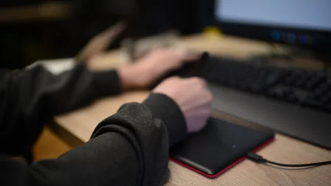 Person using graphic tablet connected to computer for digital design work Stock Footage 332620502