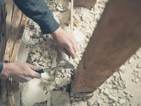 Person using hammer in rubble Stock Photos