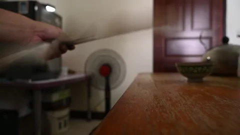 Person Using Hand Fan in Front of Oscillating Fan on a Hot Day Stock Footage 346486989