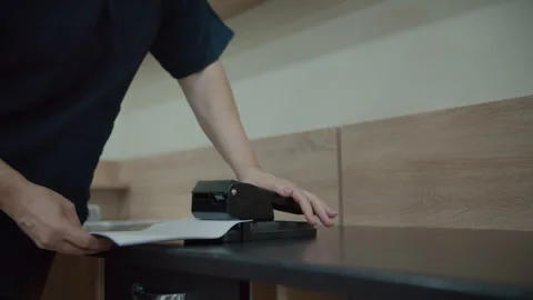 Person using heavy duty stapler on documents Stock Footage 311131885