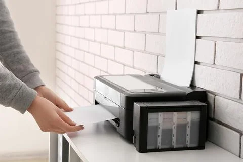 Person using inkjet printer to print paper Stock Photos
