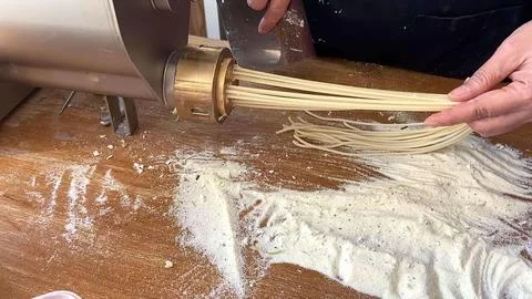 Person using kitchen mixer to prepare dough with flour and eggs Stock Photos
