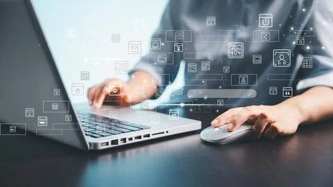 A person using a laptop and computer mouse with floating digital interface .. Foto stock