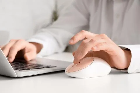 Person using laptop and computer mouse Stock Photos