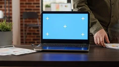 Person using laptop with blue plus signs screen Stock Photos