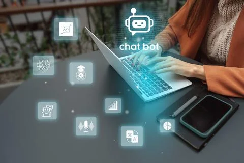Person using a laptop with chatbot icons and digital graphics in a modern Stock Photos
