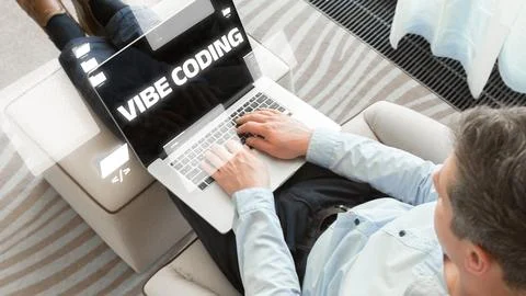 Person using a laptop to code and work on vibe coding at home in a relaxed Fotos de archivo