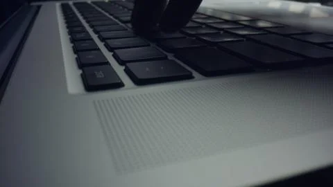 Person using laptop computer. Man hands typing on black keyboard of laptop 写真素材
