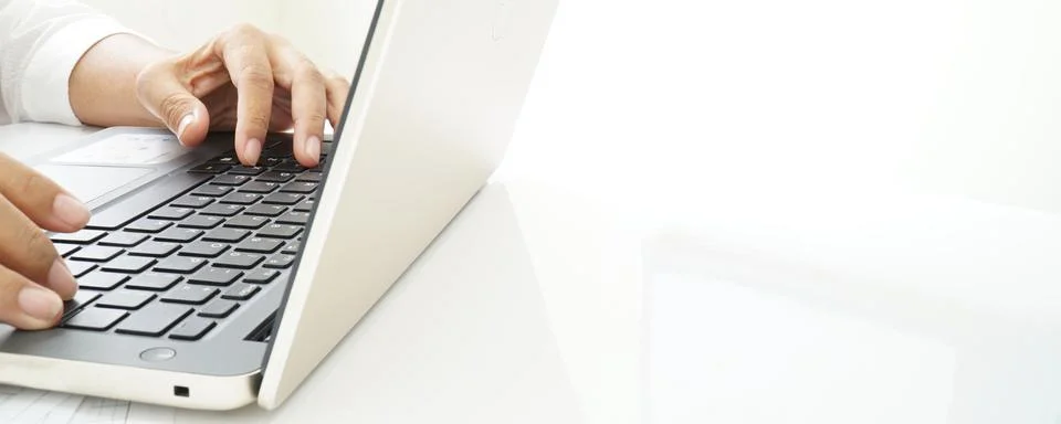 A person using a laptop computer. Stock Photos