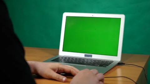 A person using a laptop computer sitting on top of a table Stock Footage