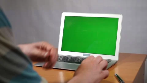A person using a laptop computer sitting on top of a table Stock Footage 132451871