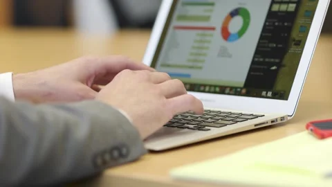 A person using a laptop computer sitting on top of a desk Video stock 155534923