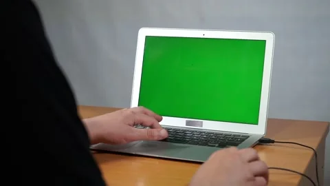 A person using a laptop computer sitting on top of a table Video stock 156723366