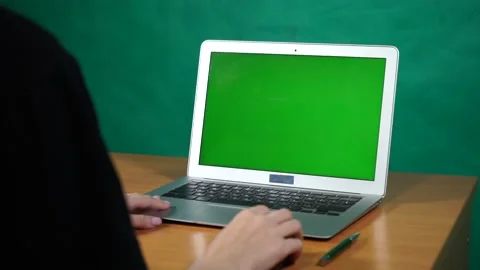 A person using a laptop computer sitting on top of a table Video stock 156723391