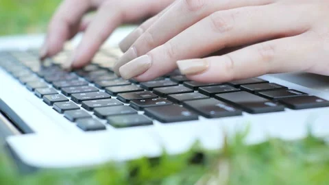A person using a laptop computer sitting on top of a keyboard 스톡 동영상 157864075
