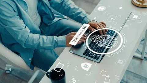 Person using a laptop with digital elements related to deep fake technology Stock Photos