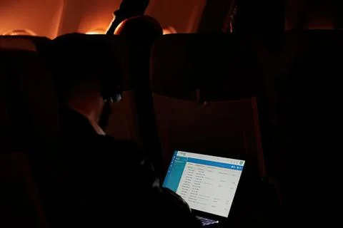 Person using laptop in dimly lit room Stock Photos