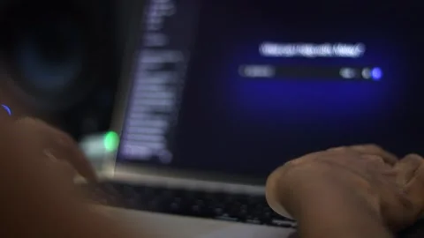 Person Using Laptop During Software Installation and Computer Setup Видео 340450430