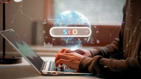 A person using a laptop with a glowing digital holographic SEO search bar a.. Stock Footage 326707470