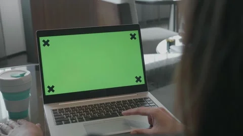 Person Using Laptop with Green Screen in Contemporary Workspace Stock Footage 315976573