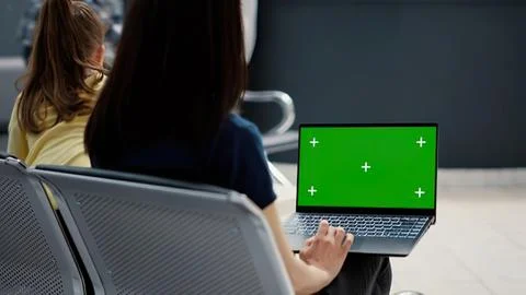 Person using laptop with green screen in airport Stock Photos