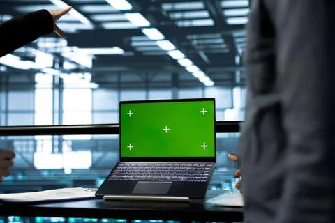 Person using laptop with green screen in modern office Stock Photos