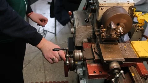 A person using a lathe to make a piece of metal Stock Footage 331252013