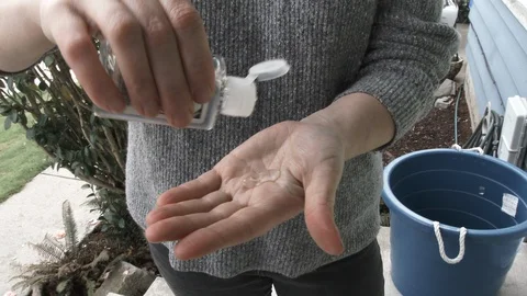 Person Using Liquid Hand Sanitizer Before Entering Home Video stock 127585178