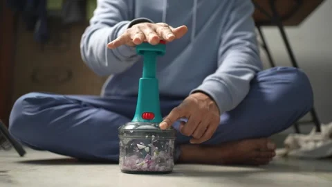 Person Using Manual Food Chopper Stock Footage 339563224