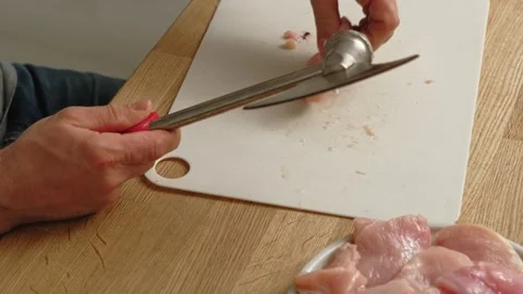 Person using meat tenderizer on raw chicken. Chef preparing pork loin slice with Stock Footage 333464311