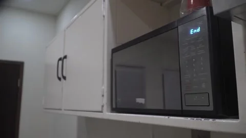 Person using a microwave oven to heat food Video stock 320967997