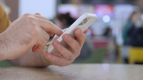 Person using mobile phone in casual setting, fingers engaged in typing Stock Footage 342588100