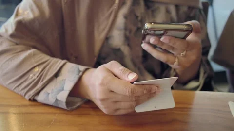 A person is using a mobile phone to scan the QR code for the menu in a cafe Stockbeeldmateriaal 339380938