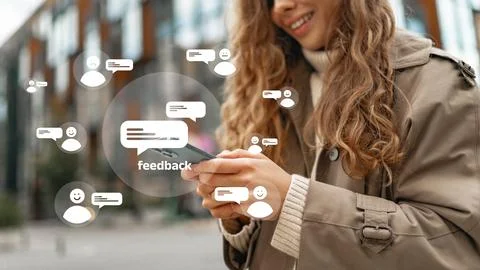 Person using mobile phone while engaging in feedback activity outdoors Stock Photos